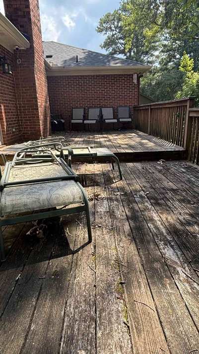 Weathered wood deck before Moore Lawncare pressure washing