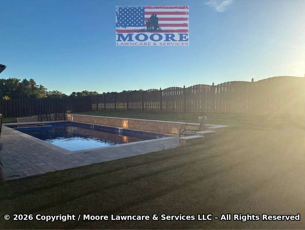 Manicured backyard and pool lawn at sunset